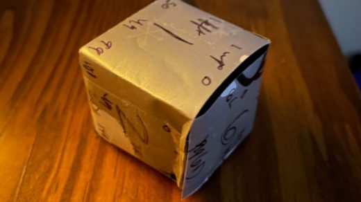 Wrapping paper cube with numbers on each edge used to help solve Day 22 quickly.